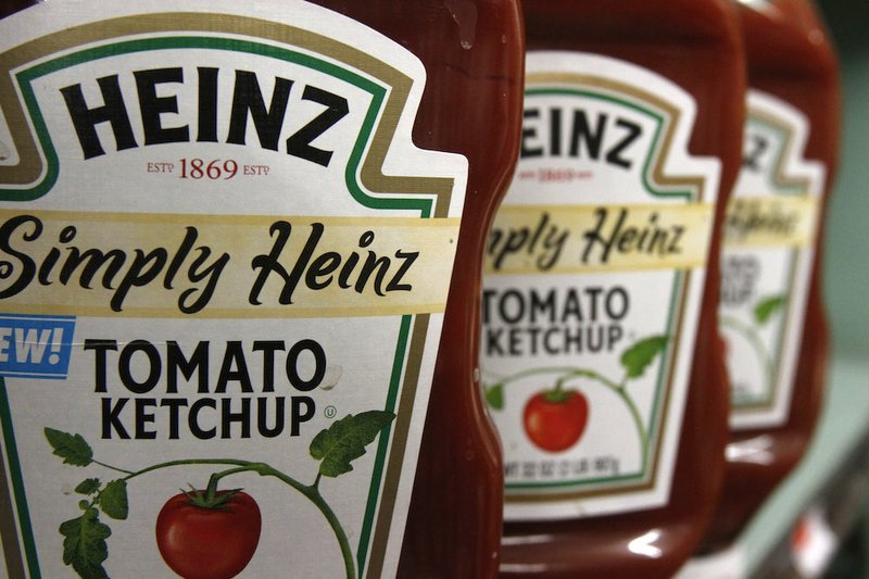 This Wednesday, March 2, 2011, file photo, shows containers of Heinz ketchup on the shelf of a market, in Barre, Vt. H.J. Heinz Co. is buying Kraft Foods Group Inc., creating what the companies say will be the third-largest food and beverage company in North America, the companies announced Wednesday, March 25, 2015. 