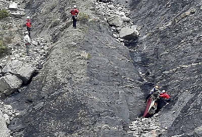 Workers search Wednesday for debris at the site in the French Alps where a Germanwings jetliner crashed Tuesday, killing all 150 people on board.