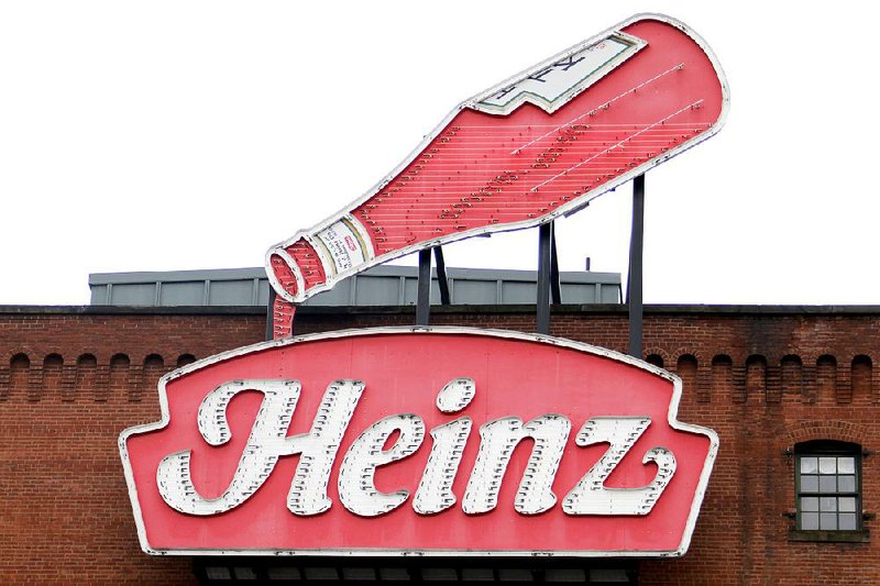 A neon Heinz ketchup sign sits on the side of the Sen. John Heinz History Center in Pittsburgh on Wednesday. H.J. Heinz Co. is buying Kraft Foods Group Inc., creating one of the largest food and beverage companies in the world. 