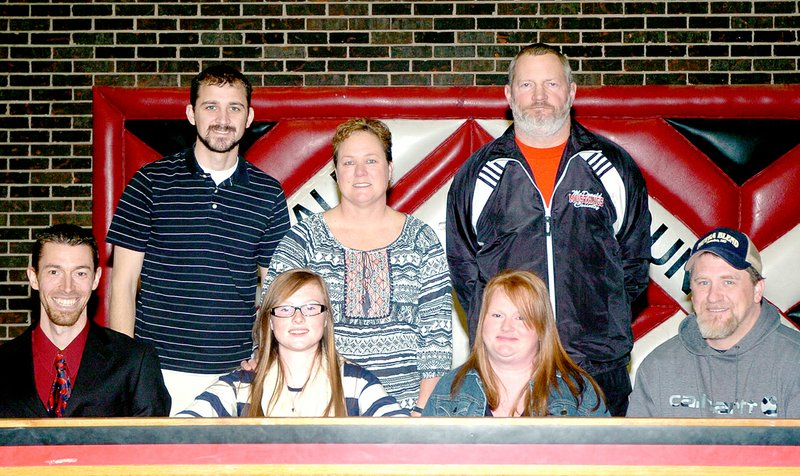 RICK PECK MCDONALD COUNTY PRESS McDonald County senior Faith Owens (second from left) recently signed a letter of intent to run track and cross Country at Cottey College in Nevada. Front row, left to right: Austin Bunn, coach at Cottey College; Owens; Jennifer Ankney (mom); and John Ankney (dad). Back row: Henri Whitehead, MCHS assistant cross country coach; Darbi Stancell, cross country coach; and Bruce Stancell, track coach.