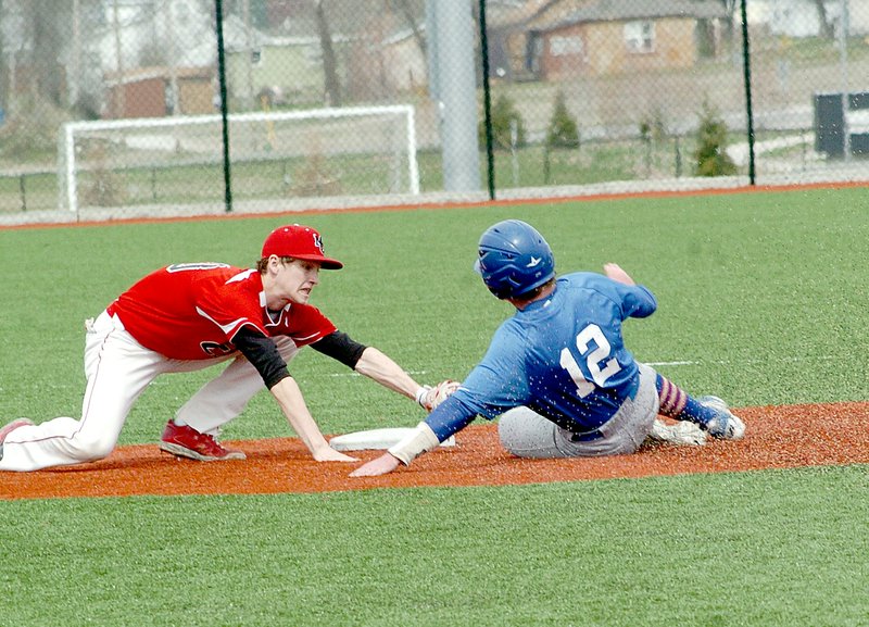 RICK PECK MCDONALD COUNTY PRESS McDonald County shortstop Dagan Stites stretches to tag out Hollister&#8217;s Blake Matthews on an attempted steal during the Mustangs 18-9 loss to open the 2015 season.