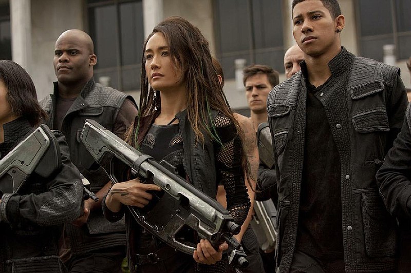 Maggie Q (left) and Keiynan Lonsdale star in The Divergent Series: Insurgent. It came in first at last weekend’s box office and made about $52 million.