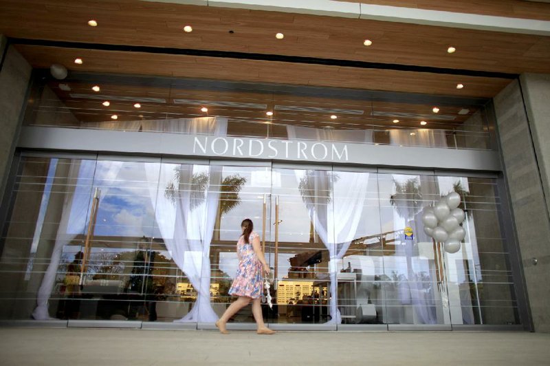 A woman peers into the new Nordstrom store at the Mall of San Juan in San Juan, Puerto Rico, on Monday. 