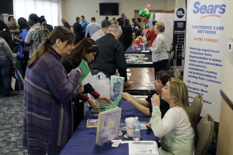 U.S. military veterans attend the annual Veterans Career and Resource Fair last month in Miami. Weekly applications for unemployment aid fell 9,000 to a seasonally adjusted 282,000, according to the Labor Department. 