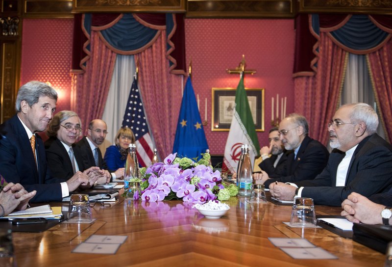 U.S. Secretary of State John Kerry, left, U.S. Secretary of Energy Ernest Moniz, second left,  National Security Council point person on the Middle East Robert Malley, 3rd left,  and European Union Political Director Helga Schmid. 4th left, head of the Iranian Atomic Energy Organisation Ali Akbar Salehi 2nd right,  and Iranian Foreign Minister Mohammad Javad Zarif right wait for the start of a meeting at a hotel in Lausanne  Switzerland on Thursday March 26, 2015 during negotiations on the Iranian nuclear programme. 