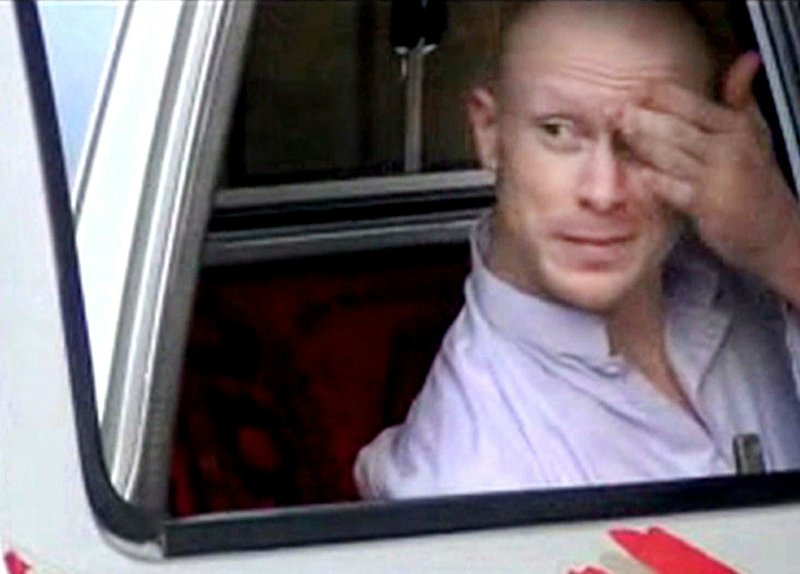In this file image taken from video obtained from Voice Of Jihad Website, which has been authenticated based on its contents and other AP reporting, Sgt. Bowe Bergdahl, sits in a vehicle guarded by the Taliban in eastern Afghanistan. The U.S. military says it will make an announcement Wednesday on the case against Sgt. Bowe Bergdahl, the soldier who left his post in Afghanistan and was held by the Taliban for five years before being released in a prisoner exchange.