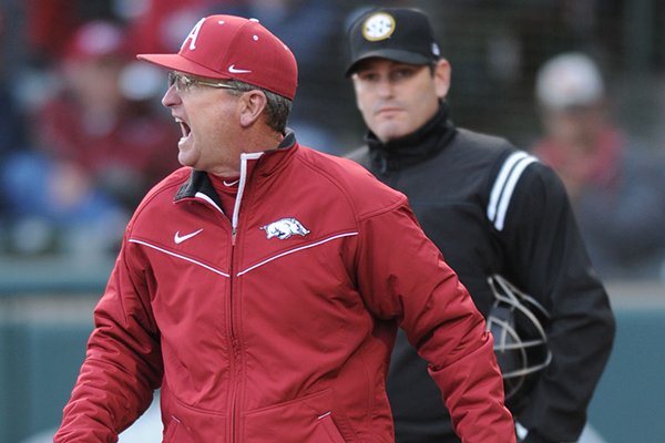 Arkansas coach Dave Van Horn argues with the umpiring crew after being ejected by plate umpire Rob Healey (right) against Mississippi during the second inning Friday, March 27, 2015, at Baum Stadium in Fayetteville.