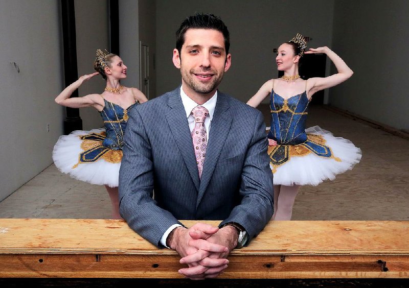 Michael Bearden, artistic director of Ballet Arkansas, in the ballet company's new space downtown on Main Street. Dancers in background are, from left, Amanda Sewell and Hannah Bradshaw.