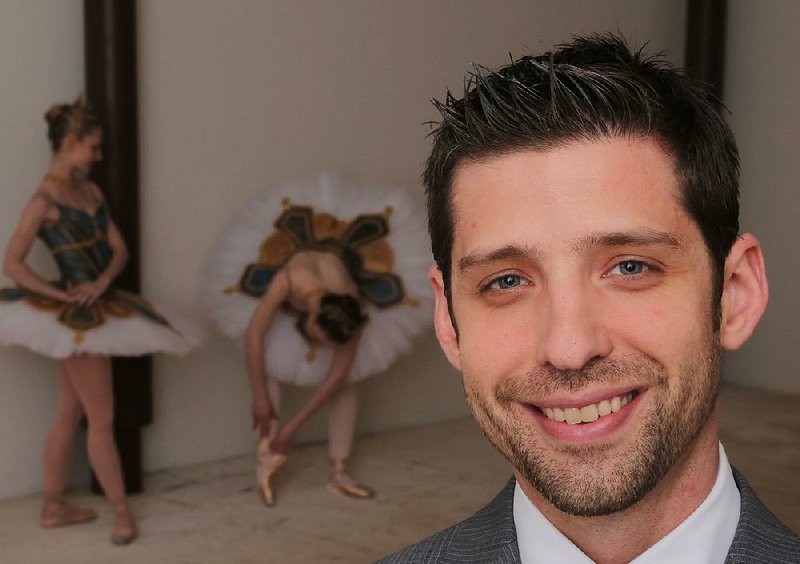 Michael Bearden, artistic director of Ballet Arkansas, in the ballet company's new space downtown on Main Street. Dancers in background are, from left, Amanda Sewell and Hannah Bradshaw.