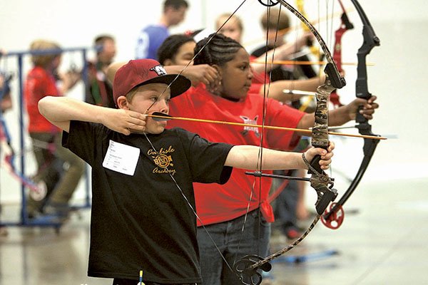 The Sentinel-Record/Richard Rasmussen ON TARGET Carlisle Elementary School student Eli Moody prepares to shoot while taking part in an archery game at the Arkansas National Archery in Schools Program State Tournament on Friday. The annual tournament is presented by the Arkansas Game & Fish Commission.