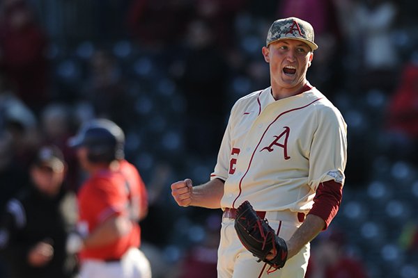 Arkansas pitcher Zach Jackson celebrates after recording the final out of the ninth inning during a game against Ole Miss on Saturday, March 28, 2015, at Baum Stadium in Fayetteville. 