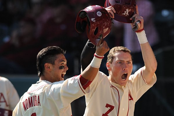 Bobby Wernes (7) of Arkansas celebrates with Rick Nomura after scoring from third while the Mississippi battery were not paying attention during the fifth inning Saturday, March 28, 2015, at Baum Stadium in Fayetteville.