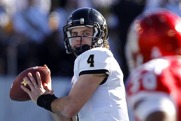 In this Jan. 4, 2014, file photo, Vanderbilt quarterback Patton Robinette (4) throws a pass down field against Houston during the first half of the BBVA Compass Bowl NCAA college football game in Birmingham, Ala. Robinette has decided to end his football career early to concentrate on medical school. (AP Photo/Butch Dill, File)