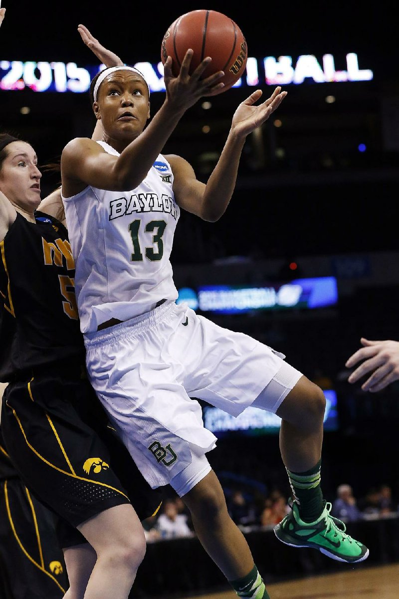 Baylor forward Nina Davis (13) drives past Iowa center Bethany Doolittle (51) during the fi rst half of Friday’s Oklahoma City Region semifinal. Davis finished with 20 points in the Bears’ 81-66 victory.