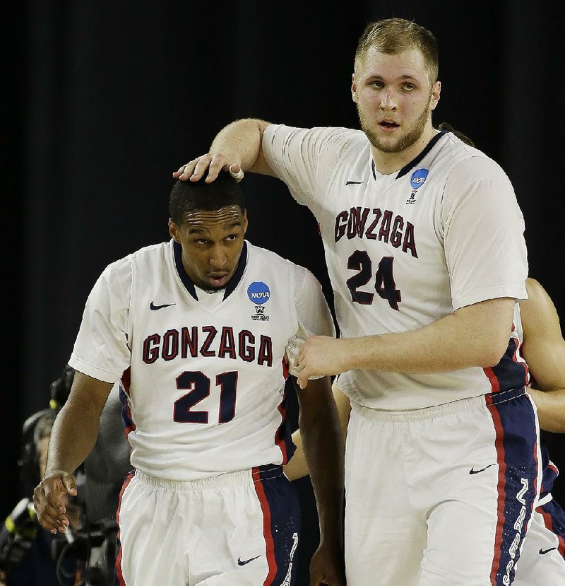 Gonzaga center Przemek Karnowski (24) celebrates with teammate Eric McClellan during the second half of Friday’s South Region semifinals at NRG Stadium in Houston. Karnowski had 18 points and nine rebounds to lead Gonzaga in a victory over UCLA.