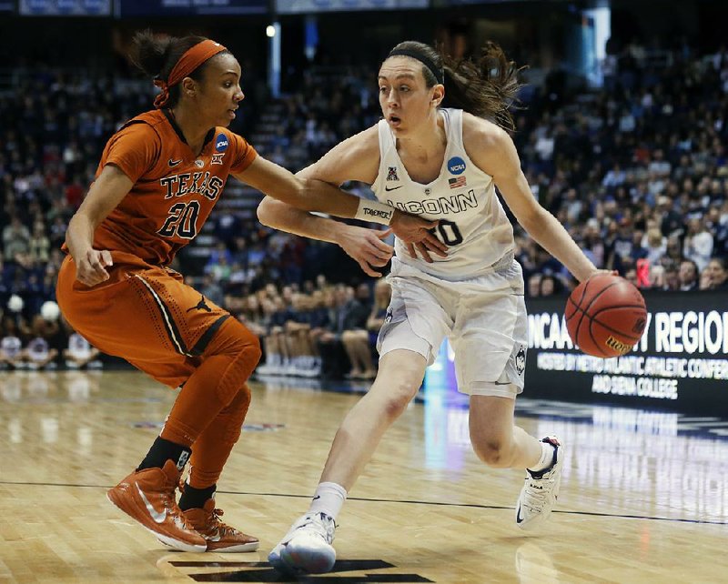 Connecticut forward Breanna Stewart (30) drives against Texas guard Brianna Taylor (20) during Saturday’s Albany Region semifinals in Albany, N.Y. Stewart finished with 31 points, 12 rebounds and 7 assists as the Huskies won 105-54. 