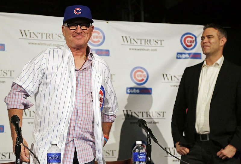 Chicago Cubs President of Baseball Operations Theo Epstein looks on as Joe Maddon, left, is introduced at the new manager of the Cubs baseball team Monday, Nov. 3, 2014, in Chicago. 