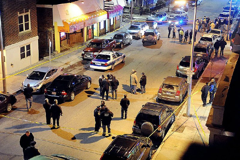 Investigators work late Friday near where a police officer was shot and critically injured during a traffic stop in Boston. 