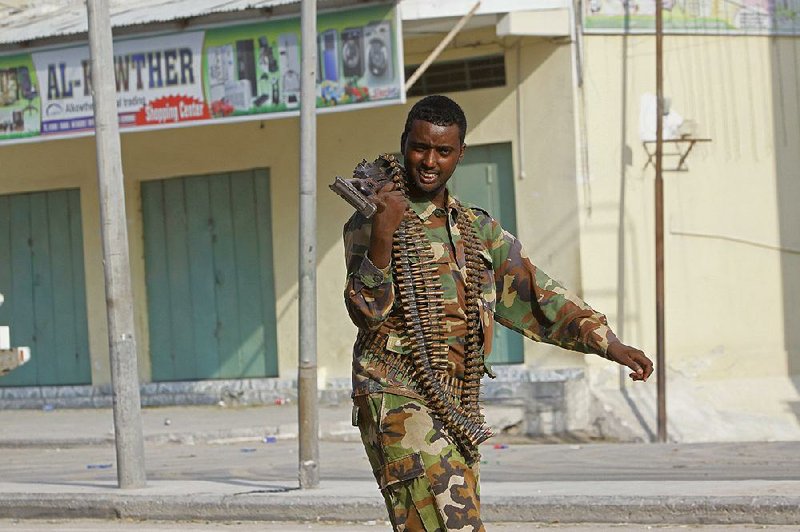 A Somali soldier walks in a street in Mogadishu as troops prevailed Saturday in dislodging militants who had occupied a hotel in the city. 