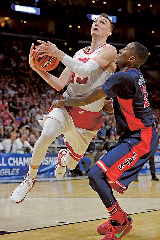 The Associated Press BEST BADGER: Wisconsin forward Sam Dekker, left, goes to the basket against Arizona's Rondae Hollis-Jefferson during the first half of the West Region final on Saturday in Los Angeles. Dekker scored a game-high 27 points and hit a pair of late three-pointers to help seal the Badgers' 85-78 win and a second-straight Final Four appearance.