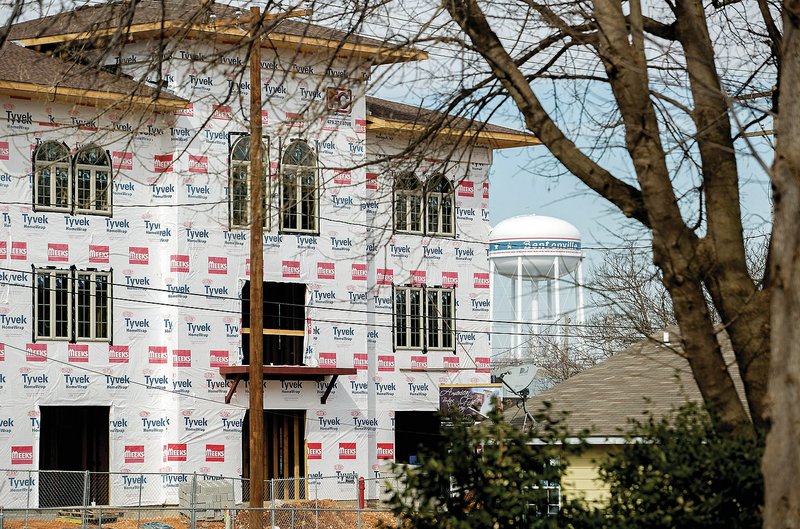 NWA Democrat-Gazette/JASON IVESTER &#8212; Construction continues Feb. 25 on the 210 Towers condominiums in downtown Bentonville. Vibrant downtowns are one way to attract the most sought-after, young employees, said Michael Harvey, Northwest Arkansas Council chief operating officer.