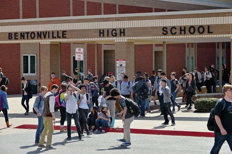 NWA Democrat-Gazette/BEN GOFF &#8212; Students pass between the north and south buildings of Bentonville High School during a class change March 12. Bentonville and Fayetteville students typically perform among the best on state math and literacy tests.