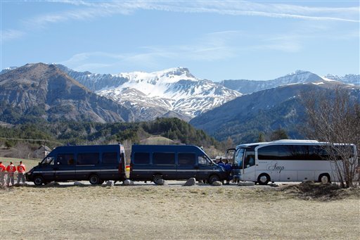 Buses of the French gendarmerie, park and mask the homage ceremony with family members of Japanese victims in the area where the Germanwings jetliner crashed in the French Alps, in Le Vernet, France, Sunday, March 29, 2015. The crash of Germanwings Flight 9525 into an Alpine mountain Tuesday killed all 150 people aboard, and has raised questions about the mental state of the co-pilot. Authorities believe the 27-year-old German deliberately sought to destroy the Airbus A320 as it flew from Barcelona to Duesseldorf. 