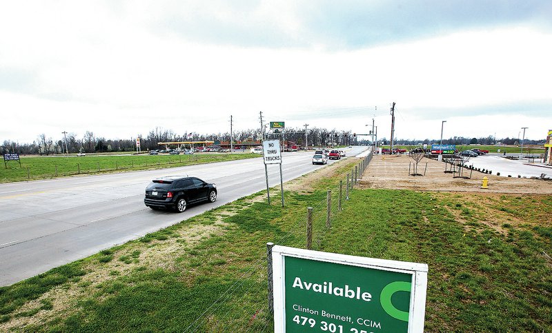 NWA Democrat-Gazette/JASON IVESTER Traffic passes along Elm Springs Road on Friday just west of the Interstate 49 interchange in Springdale. Springdale Mayor Doug Sprouse said he thinks development around the interchange will increase within the next few years.