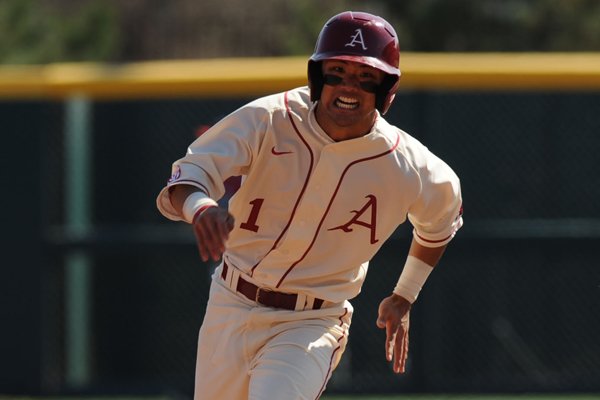 Rick Nomura of Arkansas heads to third against Mississippi Saturday, March 28, 2015, at Baum Stadium in Fayetteville.