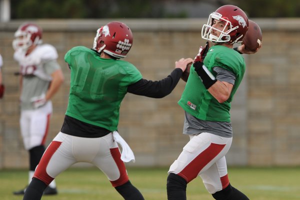 Arkansas quarterbacks Brandon Allen, right, and Austin Allen, left, work through drills during practice Saturday, Dec. 13, 2014, at the university's practice facility in Fayetteville.