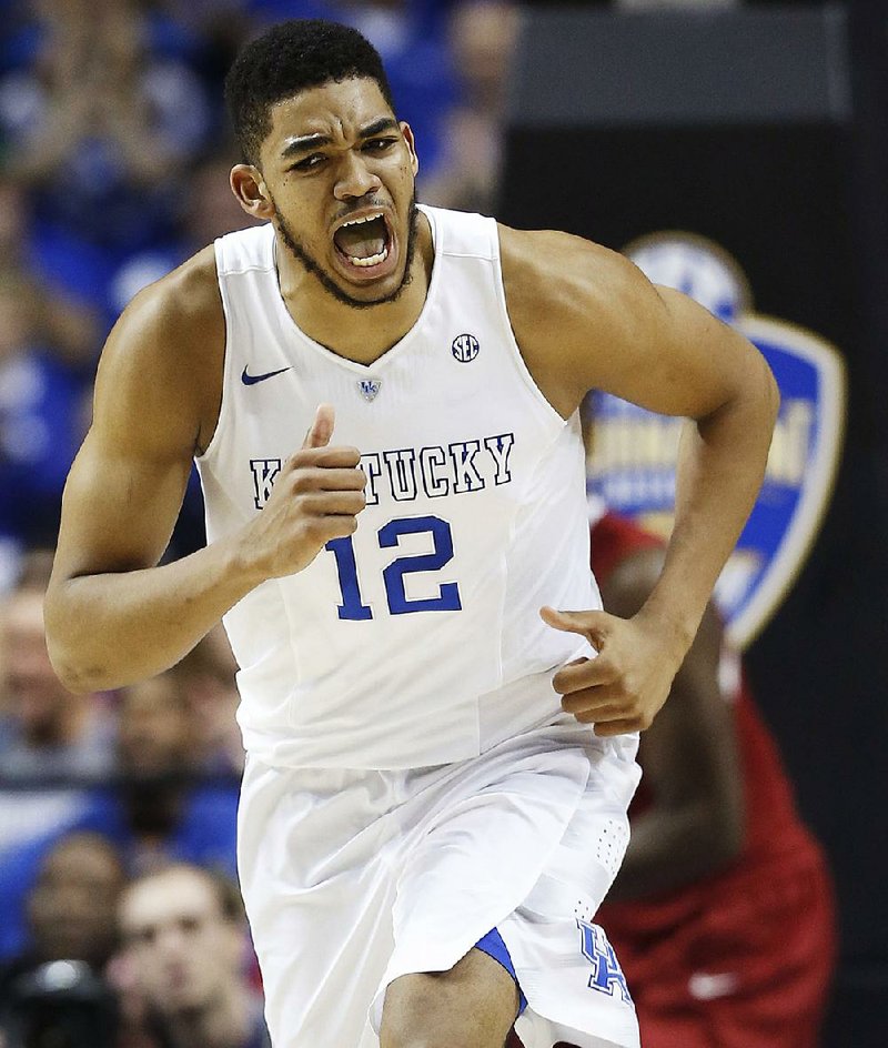 Kentucky forward Karl-Anthony Towns (12) celebrates his shot against Arkansas during the first half of the NCAA college basketball Southeastern Conference tournament championship game, Sunday, March 15, 2015, in Nashville, Tenn. (AP Photo/Steve Helber)