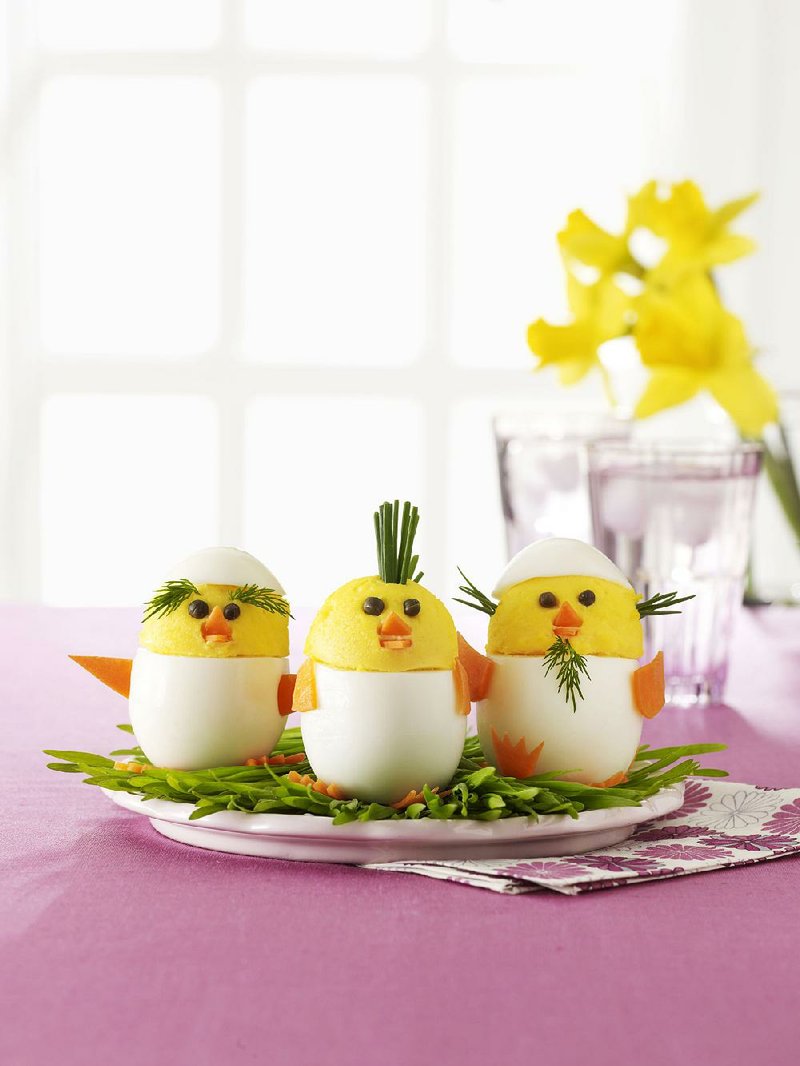 In this photo provided by Woman's Day shows "egg chicks," created by adding facial features, and personality, to traditional deviled eggs, which appear in the April 2015 issue of Woman's Day magazine. Prepare a brunch table for Easter that's big on charm and low on effort by crafting only one or two special decorations for the family occasion.  (AP Photo/Woman's Day, Kat Teutsch)