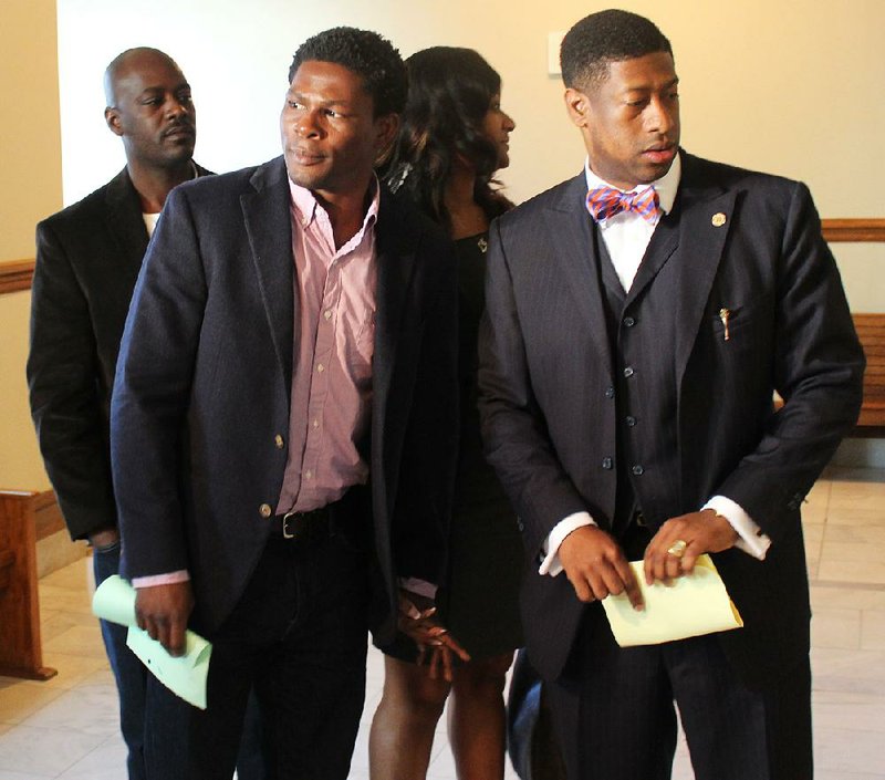 Arkansas Democrat-Gazette/GAVIN LESNICK - 03/30/2015 - Boxer Jermain Taylor leaves Pulakski County Circuit Court with his attorney, Jimmy Morris (right), March 30, 2015. Taylor pleaded innocent to accusations he opened fire and threatened a family after a Martin Luther King Jr. Day parade in Little Rock earlier this year