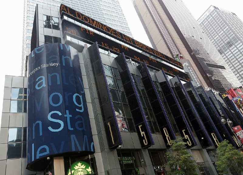 In this photo taken Aug. 12, 2014, the headquarters of Morgan Stanley, near Times Square, in New York. Two Morgan Stanley-backed Chinese companies will not be filing their financial statements on time and have stopped trading in their stocks, raising concerns about their accounting and the U.S. banking giant’s stewardship of $1.4 billion entrusted to its Asian investing arm.  (AP Photo/Richard Drew)