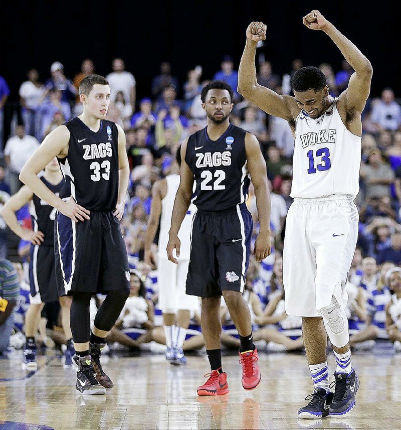 Duke's Matt Jones (13) celebrates after the second half of a college basketball regional final game against Gonzaga in the NCAA Tournament Sunday, March 29, 2015, in Houston. Duke won 66-52. (AP Photo/David J. Phillip)