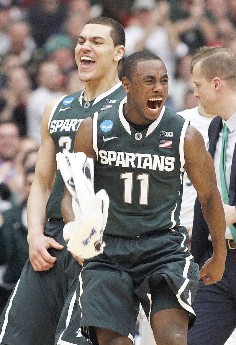 Michigan State's Lourawls Nairn Jr. (11) and Gavin Schilling (34) react during the second half of a regional final against Louisville in the NCAA men's college basketball tournament Sunday, March 29, 2015, in Syracuse, N.Y. (AP Photo/Nick Lisi)