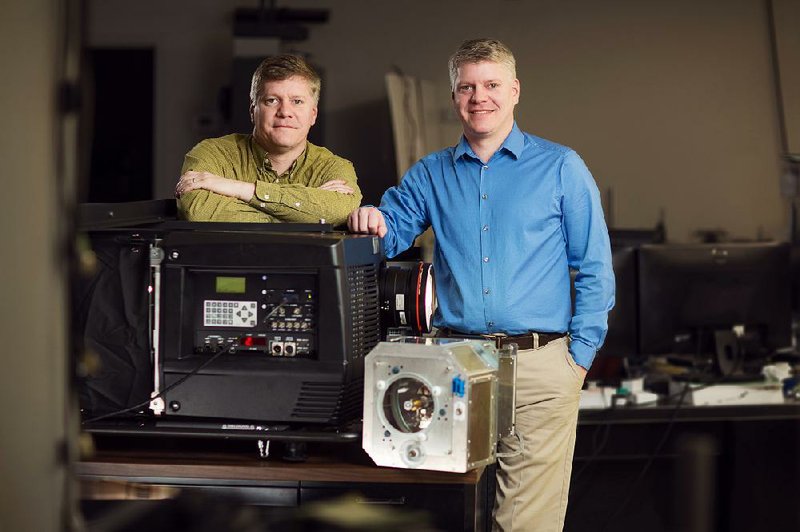 Special to the Arkansas Democrat-Gazette - 03/26/2015 - Twins Walter and William Burgess are the CEO and COO of Power Technology Inc., the company their father started 46 years ago. The firm will give a demonstration today at Ron Robinson Theater showing how their Illumina Cinema Laser System brings more color to film.

