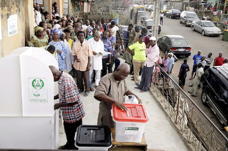 A man casts his ballot as Nigerians vote for a second day in Lagos, Nigeria, Sunday March 29, 2015. Voting in Nigeria's elections continued in certain areas on Sunday after technical problems prevented some people from casting their ballots on Saturday and despite extremist violence in the northeast and protests in the south. (AP Photo/Kunle Ogunfuyi)