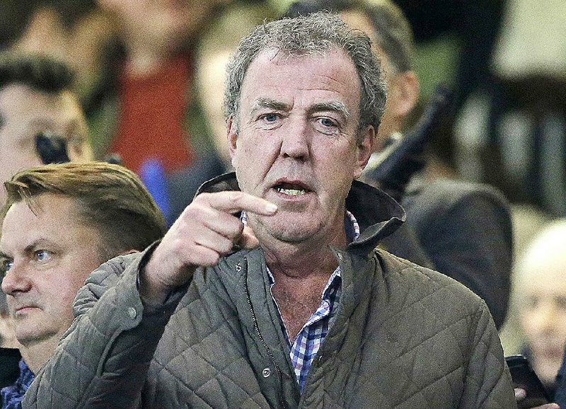 FILE - In this Wednesday, March 11, 2015 file photo,  TV host Jeremy Clarkson gestures as he takes his place in the stands before the Champions League round of 16 second leg soccer match between Chelsea and Paris Saint Germain at Stamford Bridge Stadium in London.  A television station owned by the Russian defense ministry is offering a job to former "Top Gear" host Clarkson. (AP Photo/Matt Dunham, File)