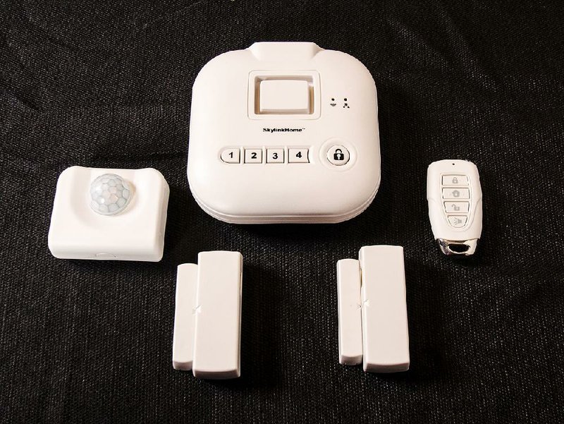 Special to the Arkansas Democrat-Gazette - 03/27/2015 - The Skyline SK-200 Alarm System Starter Kit includes an Internet hub (top) and (from left) a motion sensor, two window/door sensors and a key fob remote control. 
