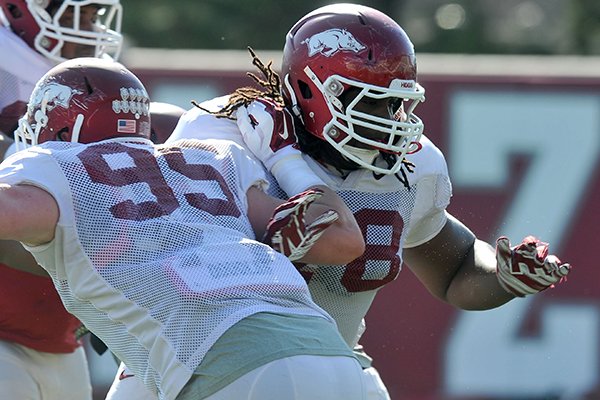 Arkansas defensive tackle Bijhon Jackson (78) goes through drills Tuesday, March 31, 2015, in Fayetteville. 