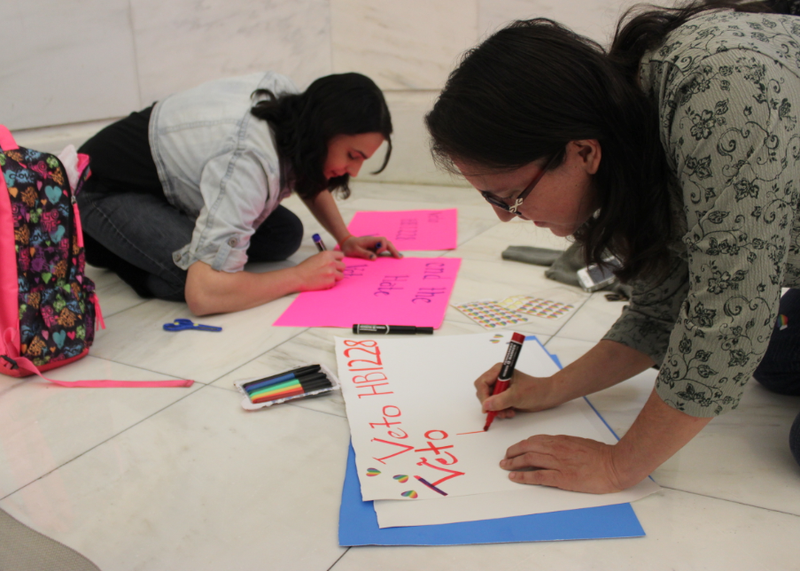 Geneva Gernold, right, and Robin Allen make signs opposing House Bill 1228 Tuesday in the state Capitol.