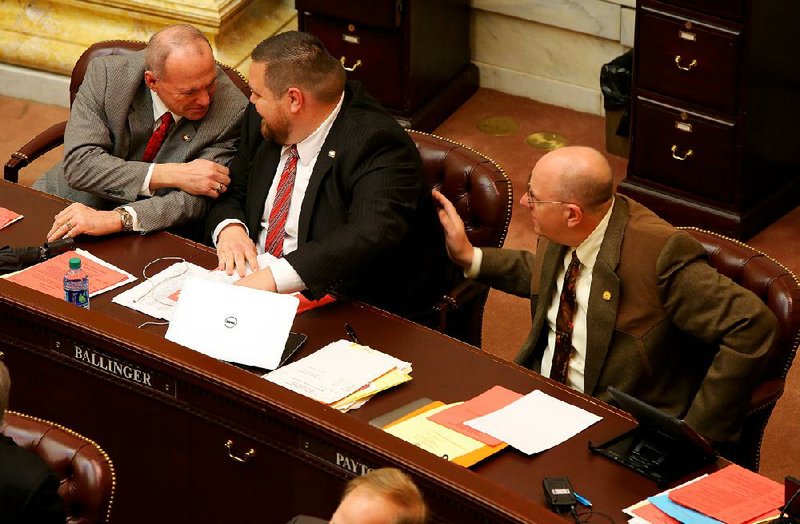 Rep. Mike Holcomb (left), D-Pine Bluff, and John Payton (right), R-Wilburn, talk with Rep. Bob Ballinger after a final amendment to Ballinger’s Religious Freedom Restoration Act was approved Tuesday, March 31, 2015, in the House. 