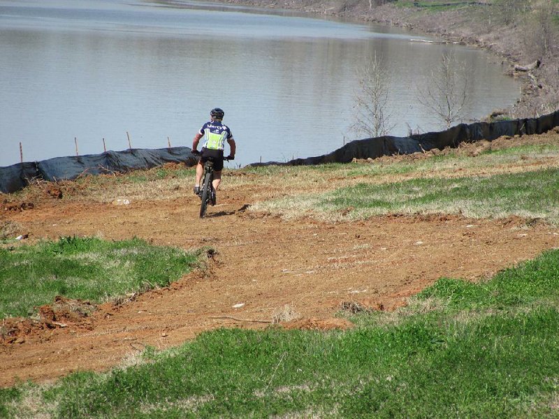 Biker Bob Robinson didn’t wait for the Greg Smith Riverwalk in Fort Smith to be completed before making a run on a roughed-out section Tuesday. A groundbreaking ceremony was held for the 1.6-mile section that will connect the city’s river trail after its completion. 