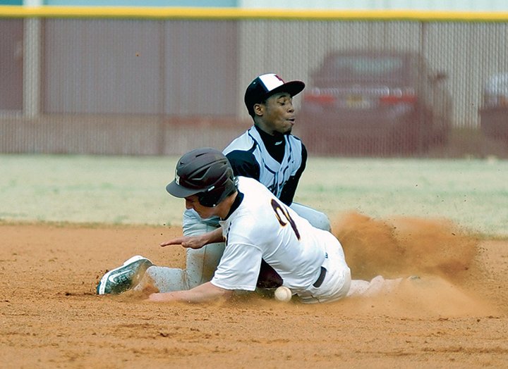 The Sentinel-Record/Mara Kuhn SLIDE AT SECOND: Lake Hamilton’s Jacob Treat, right, slides into second base as Pine Bluff’s Braylen Jones attempts to tag him out in a 6A-South baseball game Tuesday. The visiting Pine Bluff Zebras won 4-2.