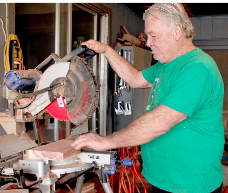 PHOTOS/LYNN KUTTER ENTERPRISE-LEADER Gary Flack of Gary Flack&#8217;s Wood Creations in Farmington cuts a piece of wood in his shop located at the corner of West Main and Angus Lane, across from Farmington High School. He fell into the business after making a table for his girl friend.