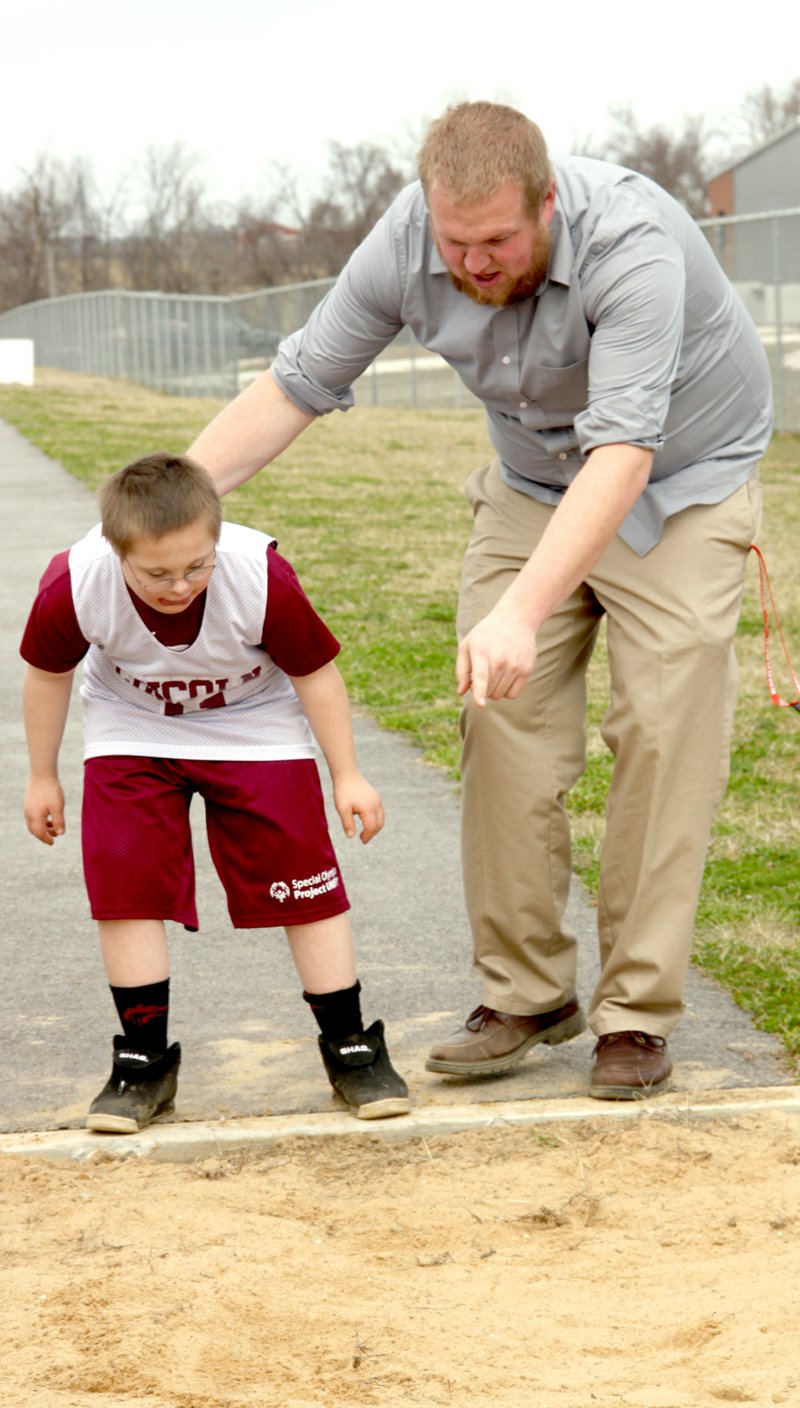 Photos by LYNN KUTTER ENTERPRISE-LEADER Ryan Acord, special education teacher at Lincoln Middle School, gives some pointers to Ryan Smith on the long jump. Acord has started a Special Olympics team with his students and they are training for the Area 3 track meet on April 25 in Fayetteville.