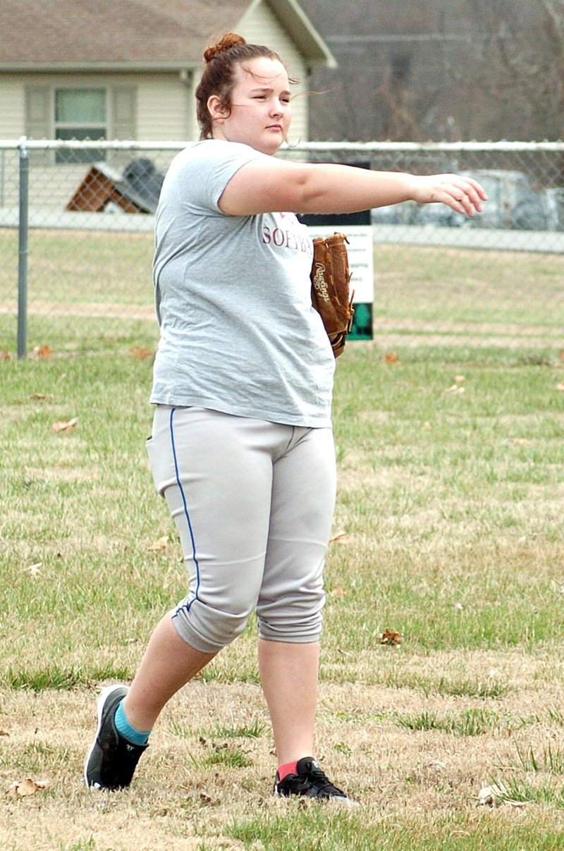 Photo by Mike Eckels Cameron Shaffer throws a few balls during one of Decatur softball team&#8217;s rare practices at Edmiston Park March 12. The fields were so wet and muddy that the team was forced to practice in either Peterson Gym or on the football field.