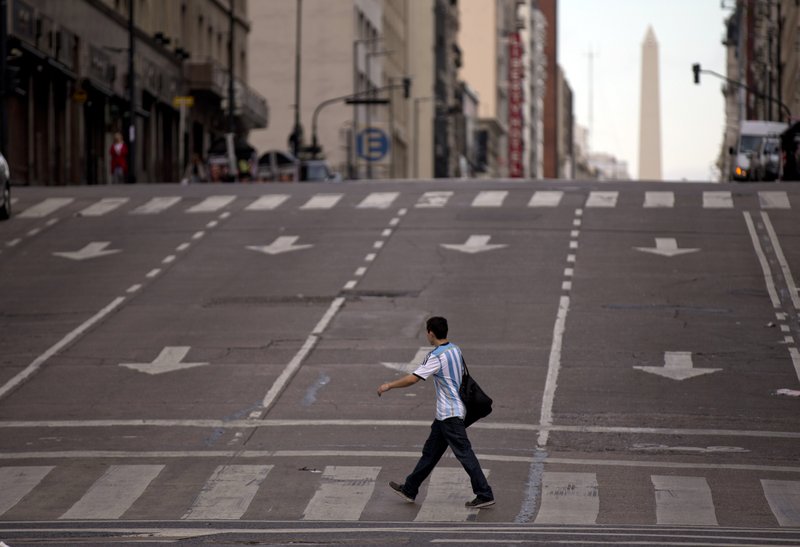 A man crosses an avenue during a transportation strike in Buenos Aires, Argentina, Tuesday, March 31, 2015. Many businesses were shuttered and streets were mostly empty Tuesday as the country's transportation unions called a nationwide strike to protest income tax rates and high inflation in the South American country.