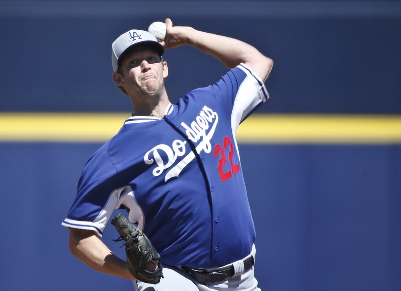  In this March 15, 2015, file photo, Los Angeles Dodgers starting pitcher Clayton Kershaw works against the Seattle Mariners in the first inning of a spring training baseball game in Peoria, Ariz. The average salary when opening-day rosters are finalized Sunday will break the $4 million barrier for the first time, according to a study of all major league contracts by The Associated Press. Dodgers pitcher Clayton Kershaw tops players at $31 million and Los Angeles leads teams at nearly $273 million, easily a record.